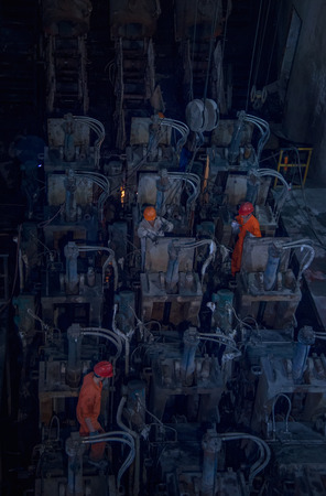 The workers are overhauling the electrodes in the steel plantの写真素材