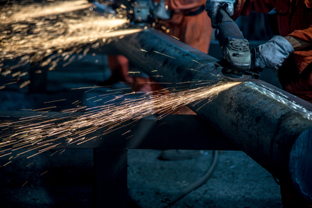 The workers in the steel mill are burnishing the steelの写真素材
