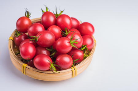 Many Cherry tomatoes packed in bamboo basketの写真素材