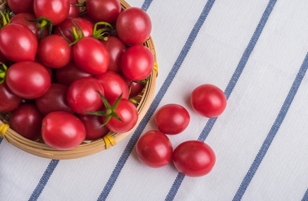 Many Cherry tomatoes packed in bamboo basketの写真素材
