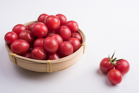 Many Cherry tomatoes packed in bamboo basketの写真素材