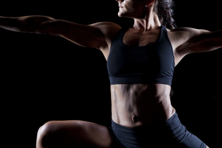 Female bodybuilder working out isolated on blackの写真素材