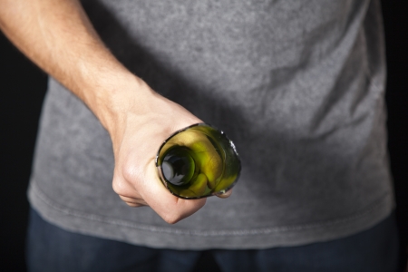 Man threatening with broken beer bottle as weaponの写真素材