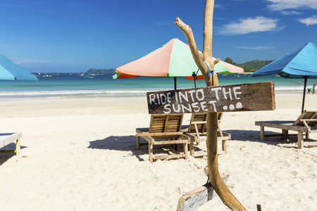 Ride into the sunset sign on tropical Balinese Beach, Lombok, Indonesiaの写真素材