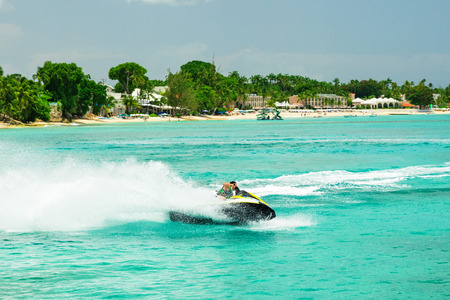 Jet ski rider on tropical pristine beach in Barbados, Caribbeanの写真素材