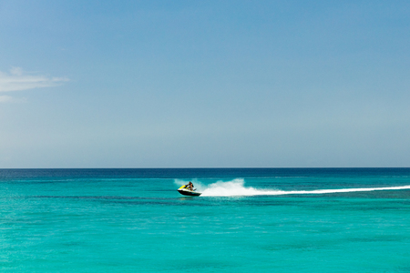 Jet ski rider on tropical pristine beach in Barbados, Caribbeanの写真素材