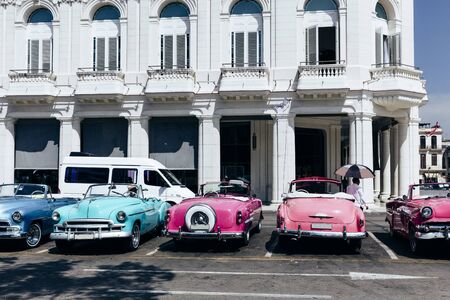 Vintage american cars parked on the street near Central Park in downtown Havana, Cubaの写真素材