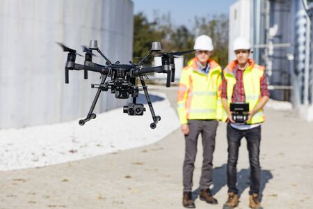 Industrial drone operators on work siteの写真素材