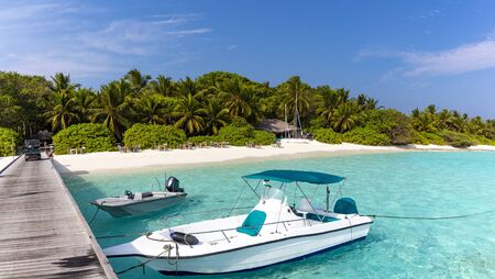 Private jetty on pristine tropical beach on a sunny day