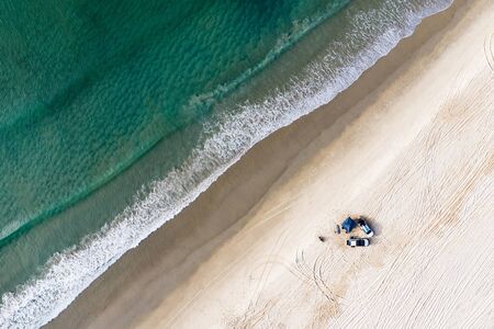 Off road cars and tent on beach in Queensland, Australia