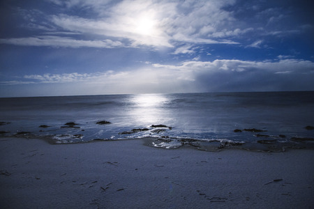 Beach moonlit night white sea winter pacific backgroundの写真素材
