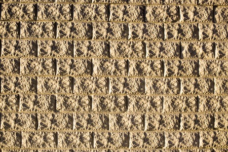 Wall of structured decorative light bricks as background or texture. Horizontal orientation