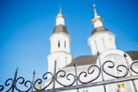 the fence and church on background bokeh.