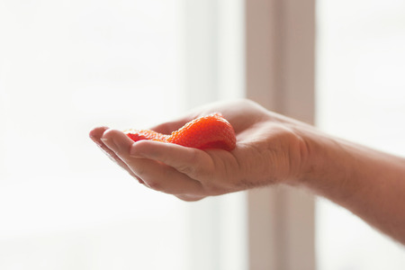 red caviar on a hand at  light background.の写真素材