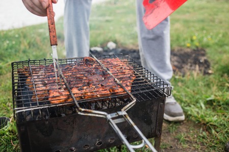 Ready meat shish kebab on skewers in a brazier. Check by a forkの写真素材