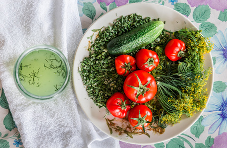 Vegetable composition for for salting: cucumbers, tomatoes, fennel, green onions and brine jar on a tableの写真素材