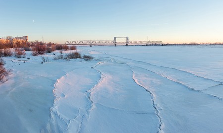 Frozen river Northern Dvina and Railway bridge in Arkhangelsk, Russia. Winter shotの写真素材