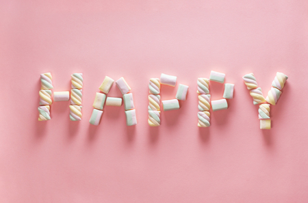 Letter HAPPY from marshmallow on gentle pink background. Flat lay. Image for Happy valentine day concept.の写真素材
