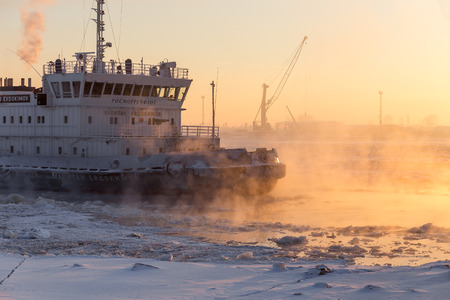 Arkhangelsk, Russia - february 8, 2017: Diesel Electric Ice Breaker Kapitan Evdokimov Breaks Ice at Sunset. Nothern Dvina River.のeditorial素材