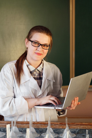 Woman graduate student with laptop computer in biotechnology laboratoryの写真素材