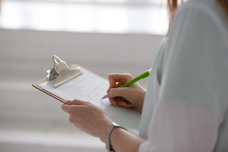 Close up of female doctor writing a prescriptionの写真素材