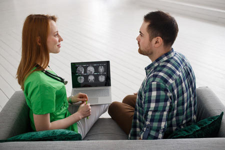 Female doctor and male patient looking at MRI concept healthcare, medical and radiology conceptの写真素材