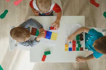 Children playing with blocks in the kindergartenの写真素材
