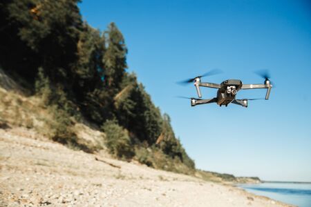 Drone DJI Mavic Pro flying over the forest landscape