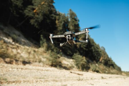 Drone DJI Mavic Pro flying over the forest landscape