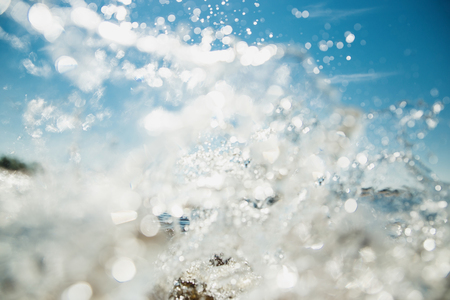 Summer swimming concept. Water splashes in sunlight and blue skyの写真素材