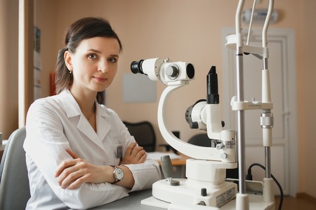 Young ophthalmologist in small cabinet of modern ophthalmological clinic
