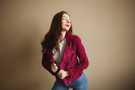 Young hipster woman clothed in magenta jacket. Beautiful eyes, long brown curly hairの写真素材