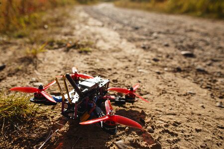 The handmade race drone in the forest roadの写真素材