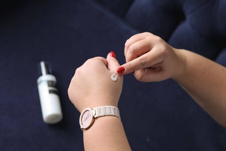Woman Hand With Cream. Closeup Beautiful Chubby Hands With Natural Manicure Nails Applying Cosmetic...