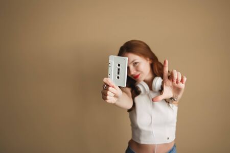 Young hipster woman with white retro audio cassette. Party 90s conceptの写真素材