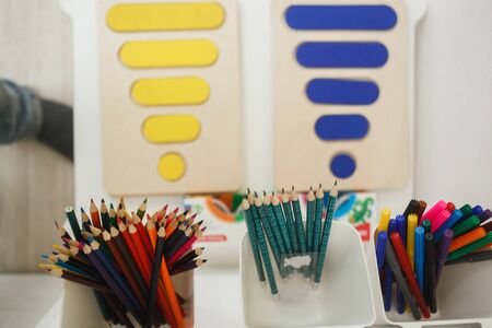 Arkhangelsk, Russia - February, 2, 2019: Colorful figurine from a colored wooden puzzles on white board. Preschool development and education of childrenのeditorial素材
