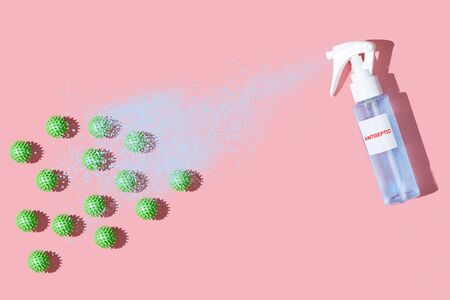 Antiseptic spray spraying against viruses on bright pink table flat lay top view. Influenza,...