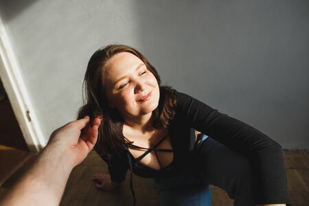 Boyfriend touches his attractive girlfriends hair in living room