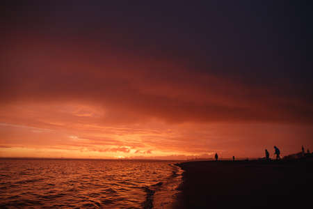 Crimson sunset the sky clears after a rain storm just long enough to show the deep red and purple clouds.の写真素材