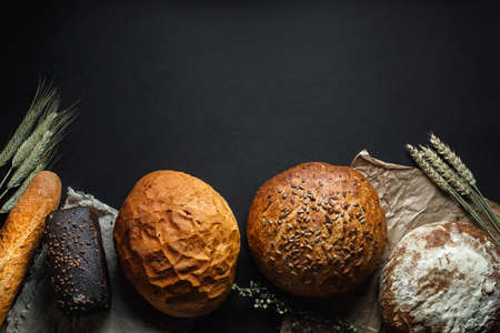 Mixed breads on black stone table. Top view with copy spaceの写真素材