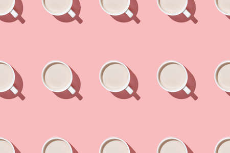 A seamless pattern of coffee and cocoa with cream on a pink table flat lay aboveの写真素材