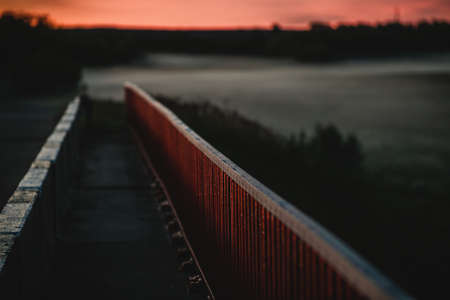 Red bridge railings on a summer nightの写真素材