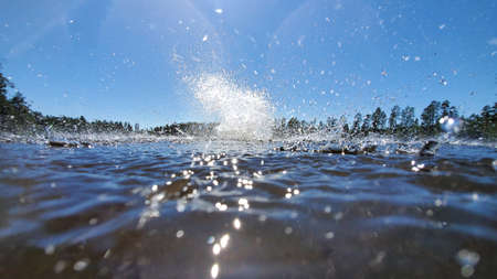 big water splash in lake after diving. Splash water on the river, beautiful colorful, bright splash