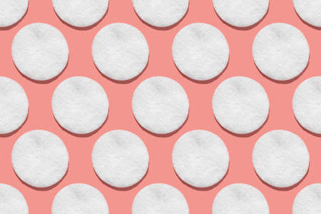 Regular seamless pattern of cotton cotton pads. Hygiene, body care. Flat lay minimal concept on a...