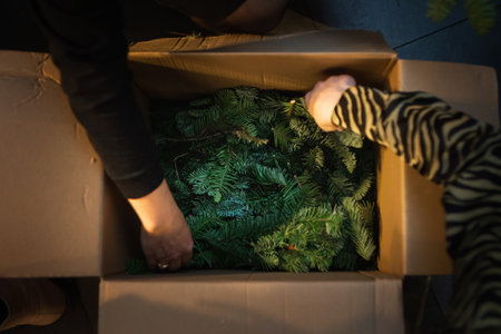 Making Christmas wreath with natural fir branches for advent. Christmas decorating ideas and hand craft. Top view of woman making festive winter and x-mas decorations.の写真素材
