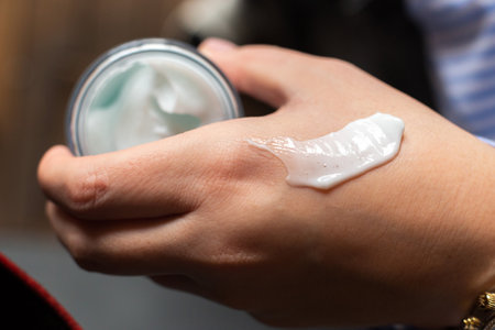 Beautiful Woman Hands. Spa and Manicure concept. Female hands with delicate manicure and white moisturizing cream. Soft skin, skincare spa salon concept banner. High quality photoの写真素材
