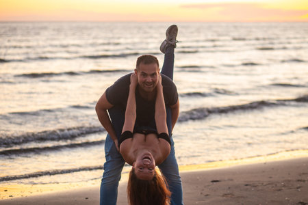 Happy couple, love and travel at the beach having fun on date, quality time and romance at sunset....