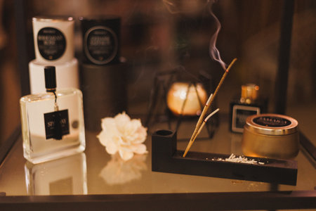 An elegant display featuring a variety of perfumes, scented candles, and incense to create a calming ambianceの写真素材