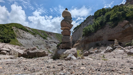 A breathtaking and stunning display of intricate stone stacking found amidst the dramatic landscapes and vibrant skiesの写真素材