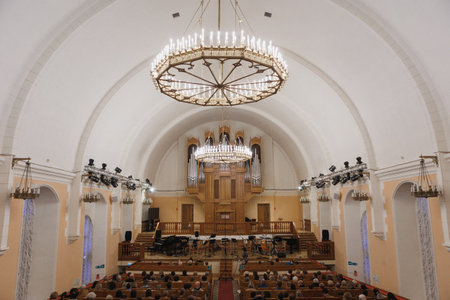 A magnificent church featuring an impressive, large chandelier elegantly hanging from the high ceiling of the worship spaceの写真素材